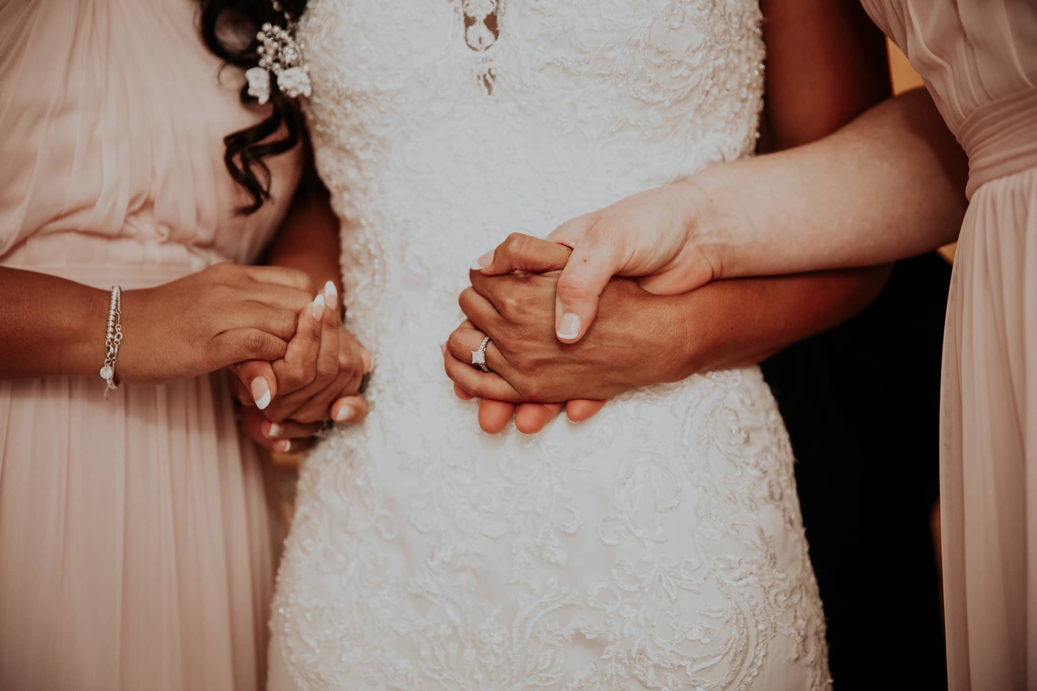 Friends Holding Hand of Bride